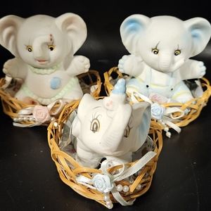 Set of 3 ceramic baby elephant figurines in wicker basket bellished.